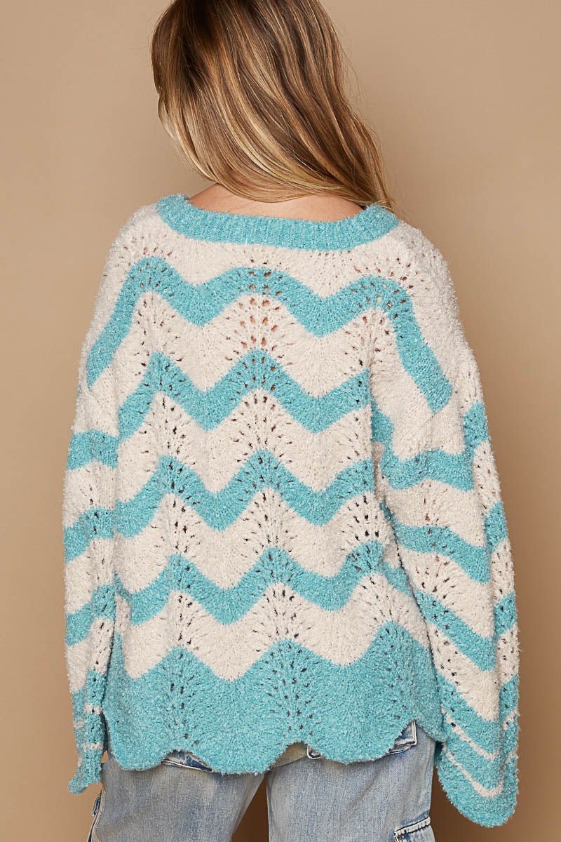 a woman wearing a blue and white sweater