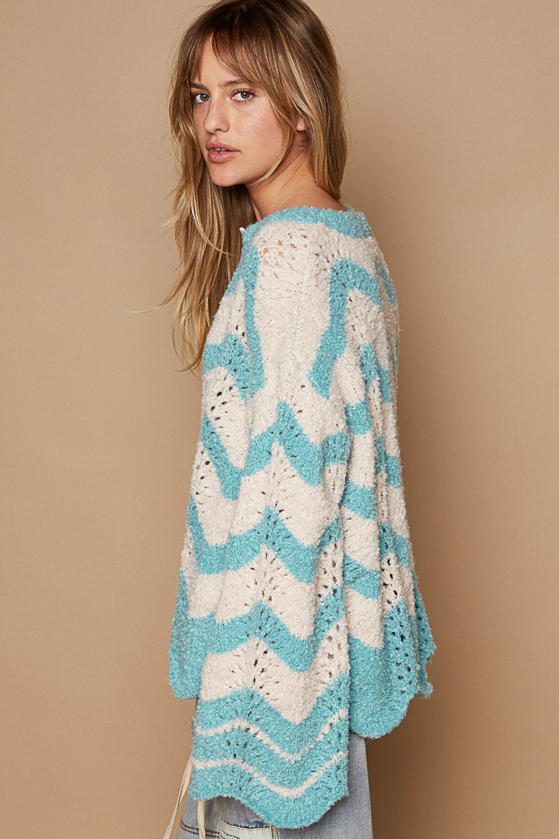 a woman wearing a blue and white sweater