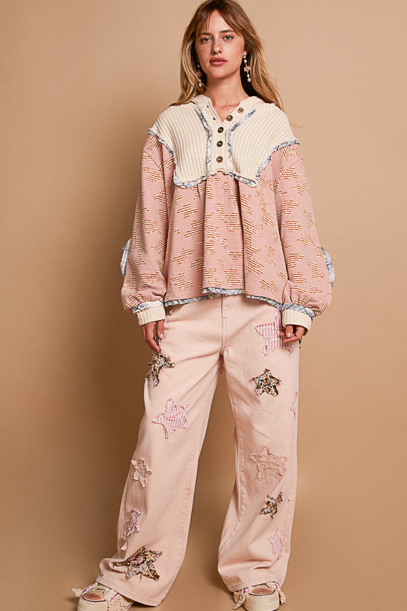 a woman standing in front of a brown wall