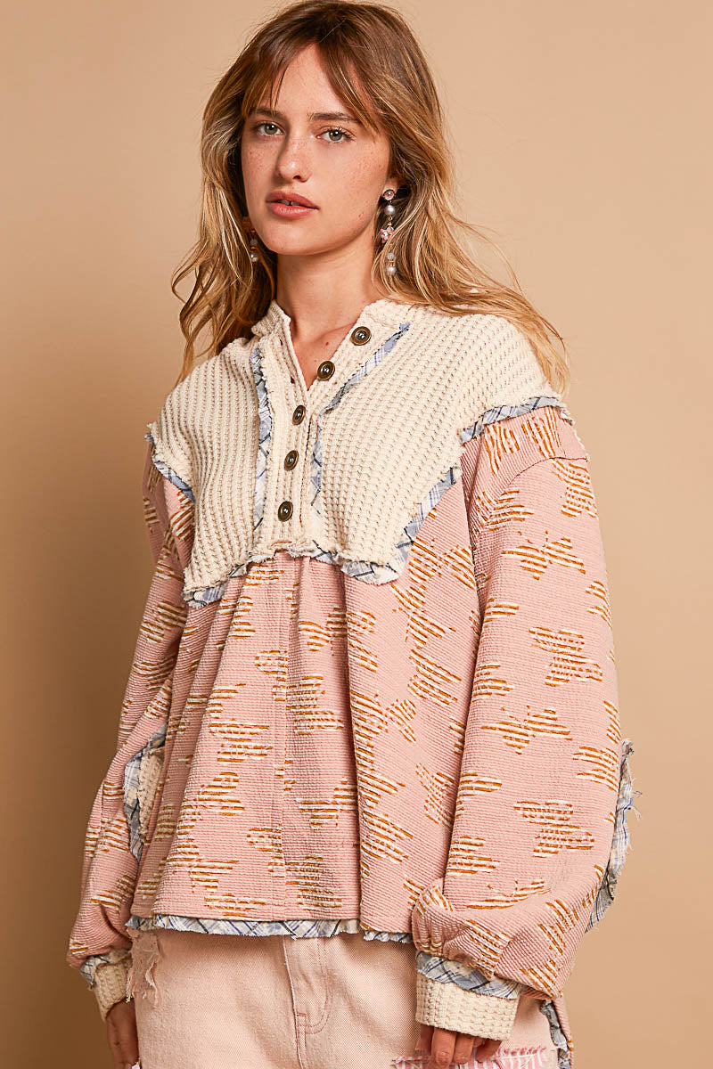 a woman standing in front of a beige wall