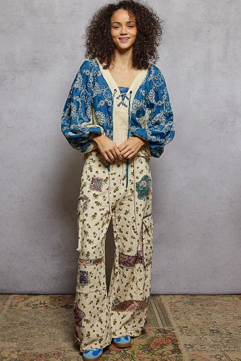 Woman wearing a blue and white patterned outfit with a gray background