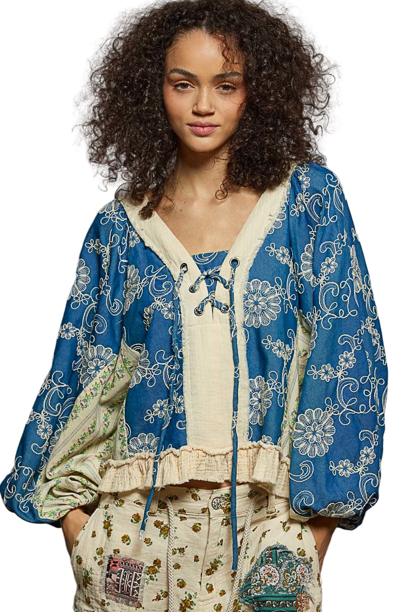 Woman wearing a blue and white patterned outfit with a white background