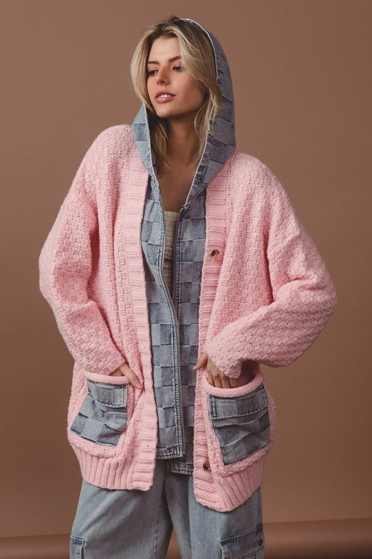 a woman wearing a pink cardigan sweater and jeans