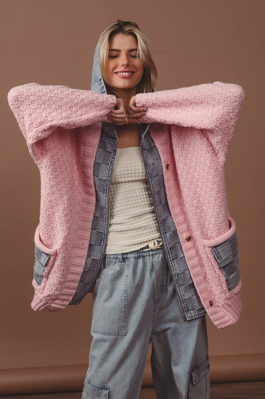 a woman wearing a pink sweater and grey pants