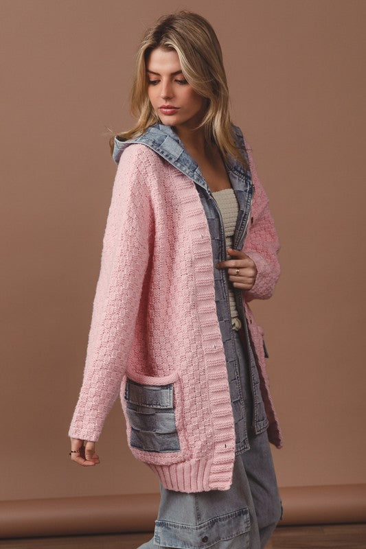 a woman wearing a pink sweater and jeans