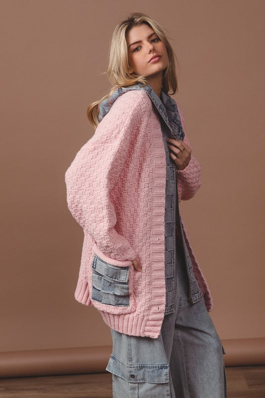 a woman wearing a pink sweater and jeans