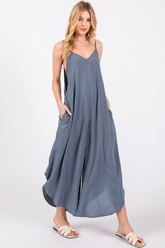 a woman wearing a gray dress and sandals