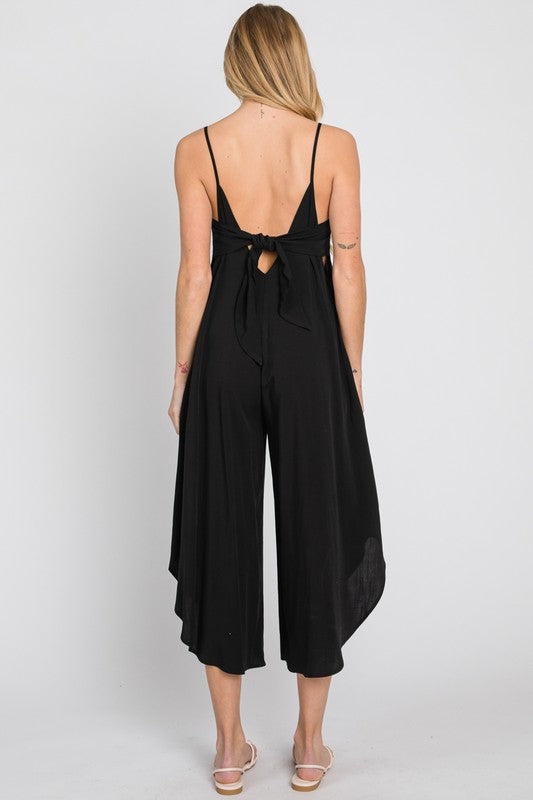 the back of a woman wearing a black jumpsuit