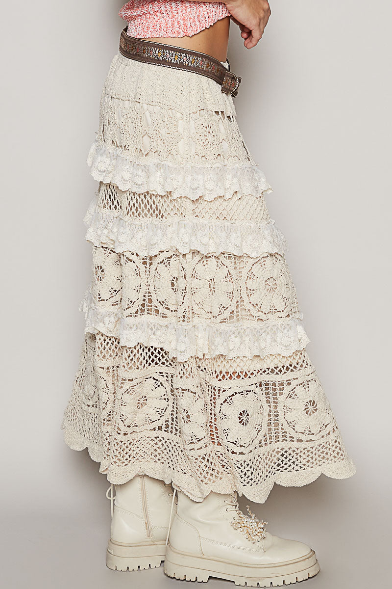 a woman in a pink top and white skirt