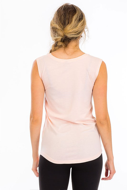 a woman wearing a pink shirt and black pants