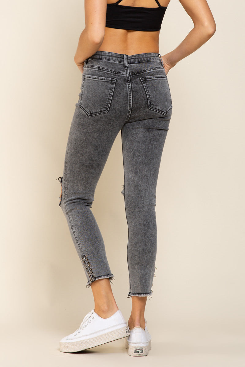 a woman in a black top and jeans