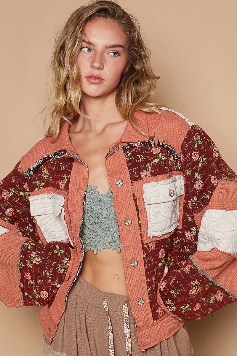 a woman wearing a crop top and a jacket