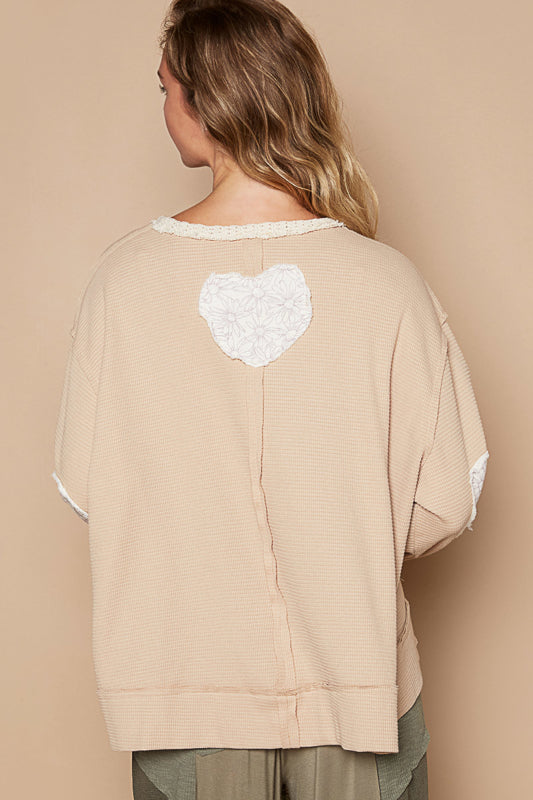 a woman wearing a sweater with a heart on it
