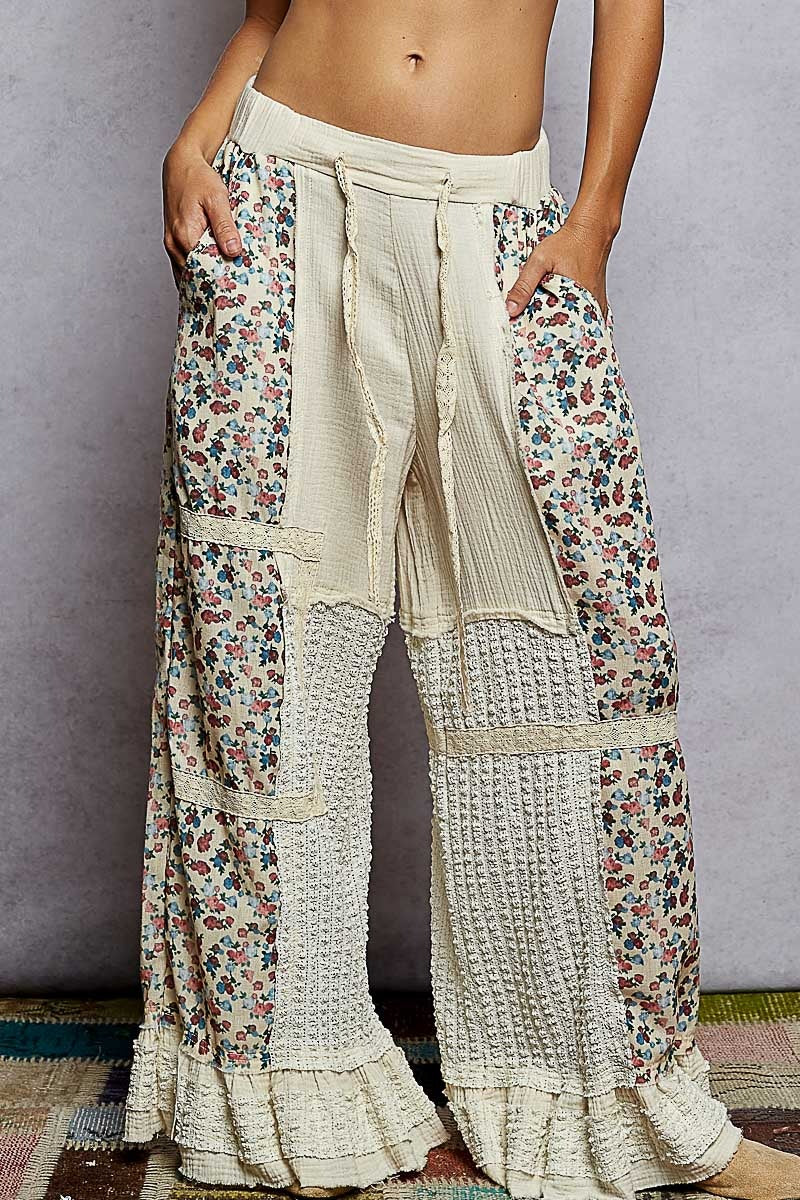 Floral and textured wide-leg pants worn by a person against a neutral background