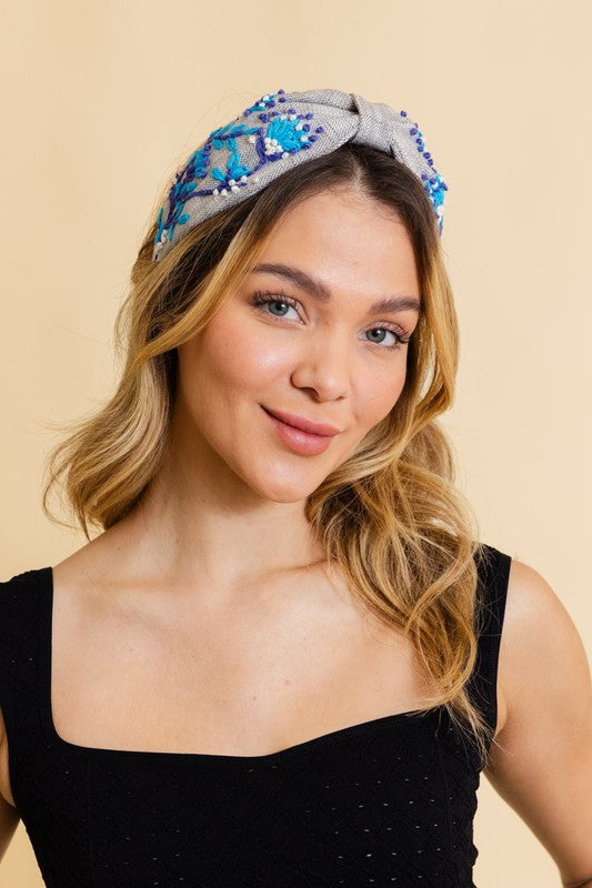a woman wearing a black top and a blue headband