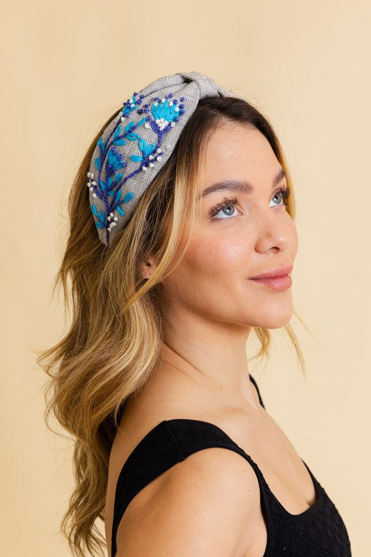 a woman wearing a black top and a blue headband