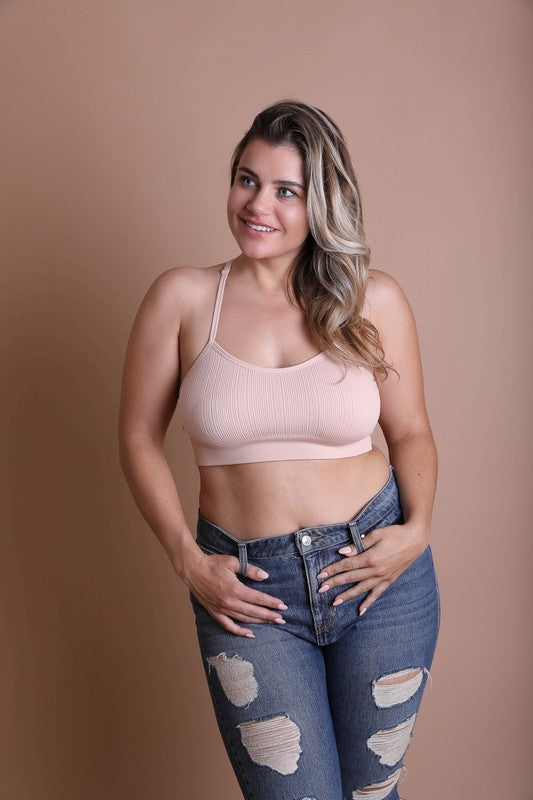 a woman posing for a picture in a pink bra top