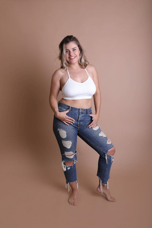 a woman posing for a picture in ripped jeans