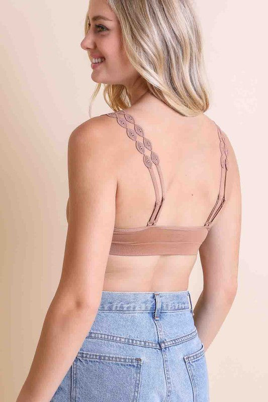 the back of a woman wearing a tan bra