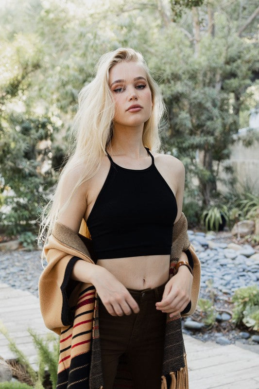 a woman with blonde hair wearing a black top