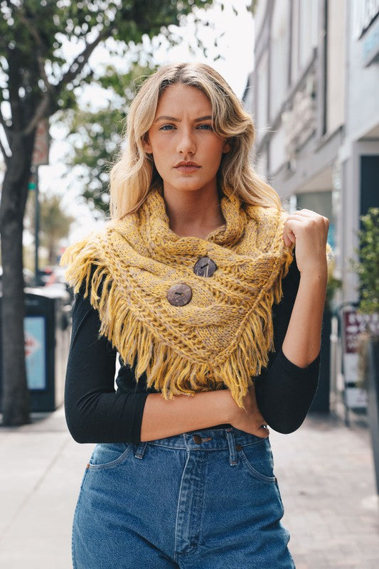 a woman wearing a yellow scarf and jeans