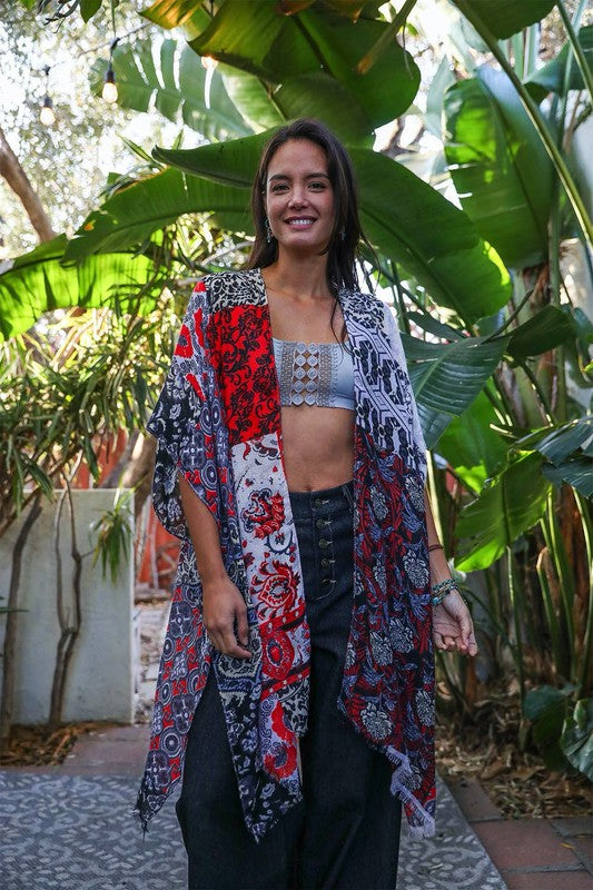 a woman standing in front of a bunch of plants