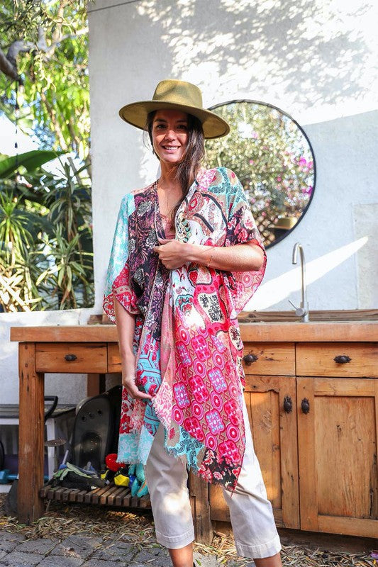 a woman standing in front of a mirror wearing a hat