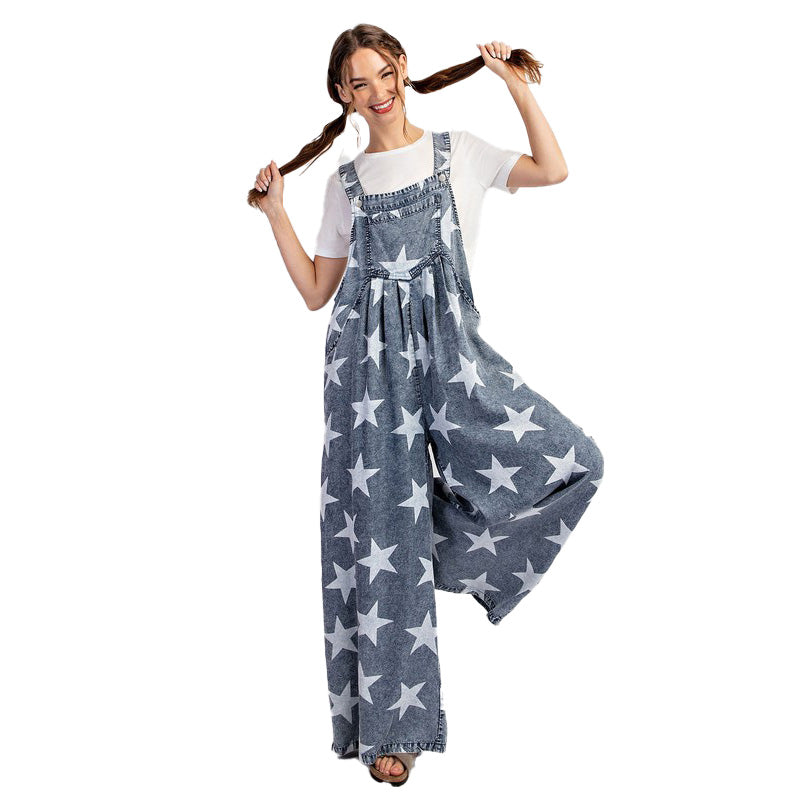 a woman holding a baseball bat while wearing a jumpsuit