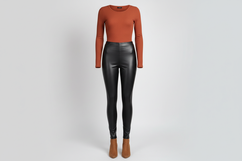 Sale Bottoms women's black faux leather leggings and terracotta ribbed top on a ghost mannequin, clean studio backdrop