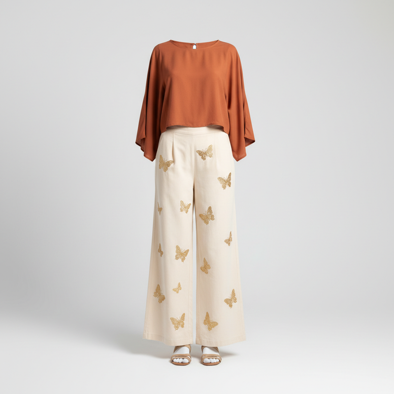 Women's wide-leg boho trousers with butterfly embroidery styled with terracotta blouse, ghost mannequin studio shot - BellanBlue