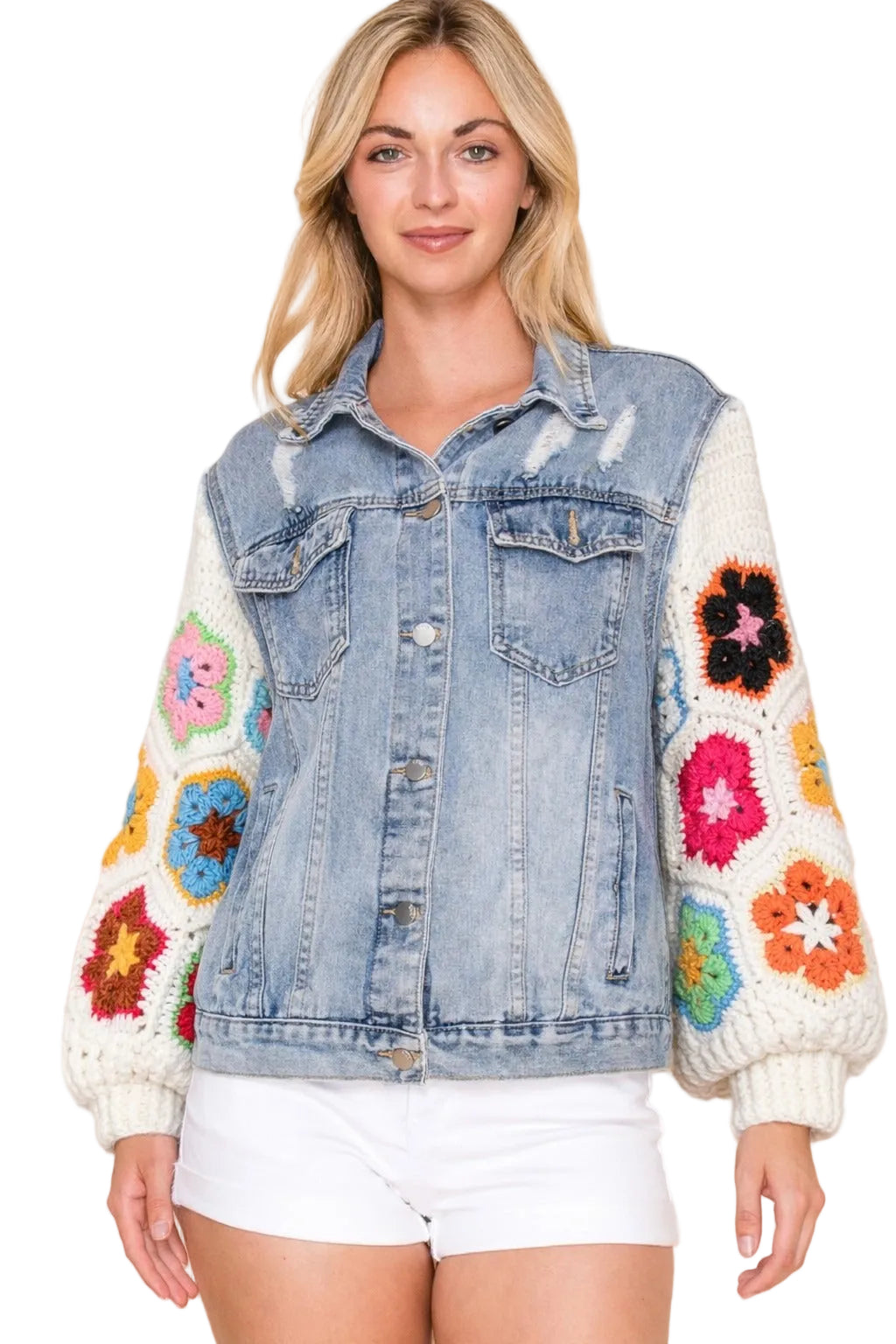 Women's light blue denim trucker jacket with multicolor granny square crochet sleeves styled with white shorts front view