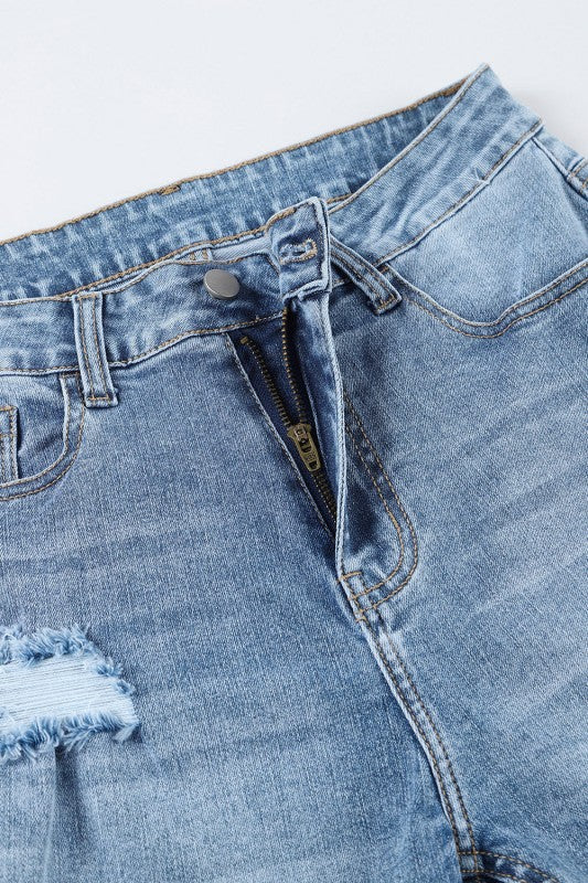 Close-up of a pair of light blue jeans with a zipper and button.