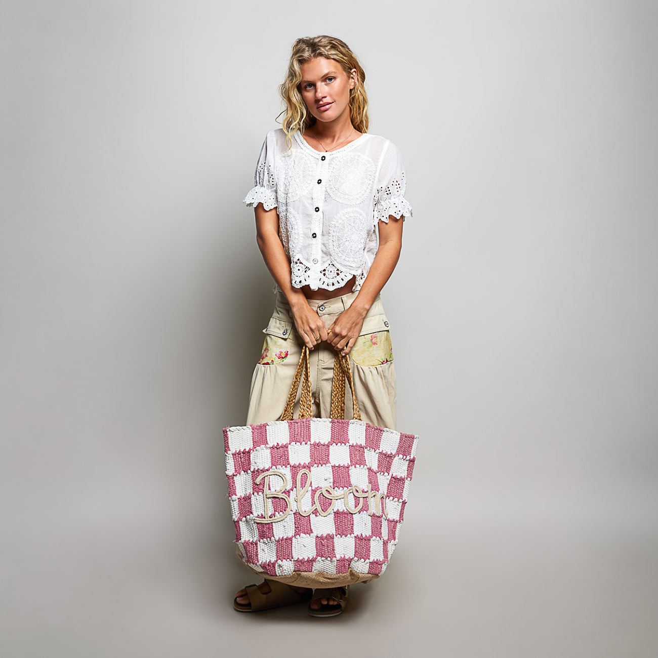 POL Clothing Pink BLOOM handwoven tote bag on model, full-length front view with checkerboard pattern and braided handles
