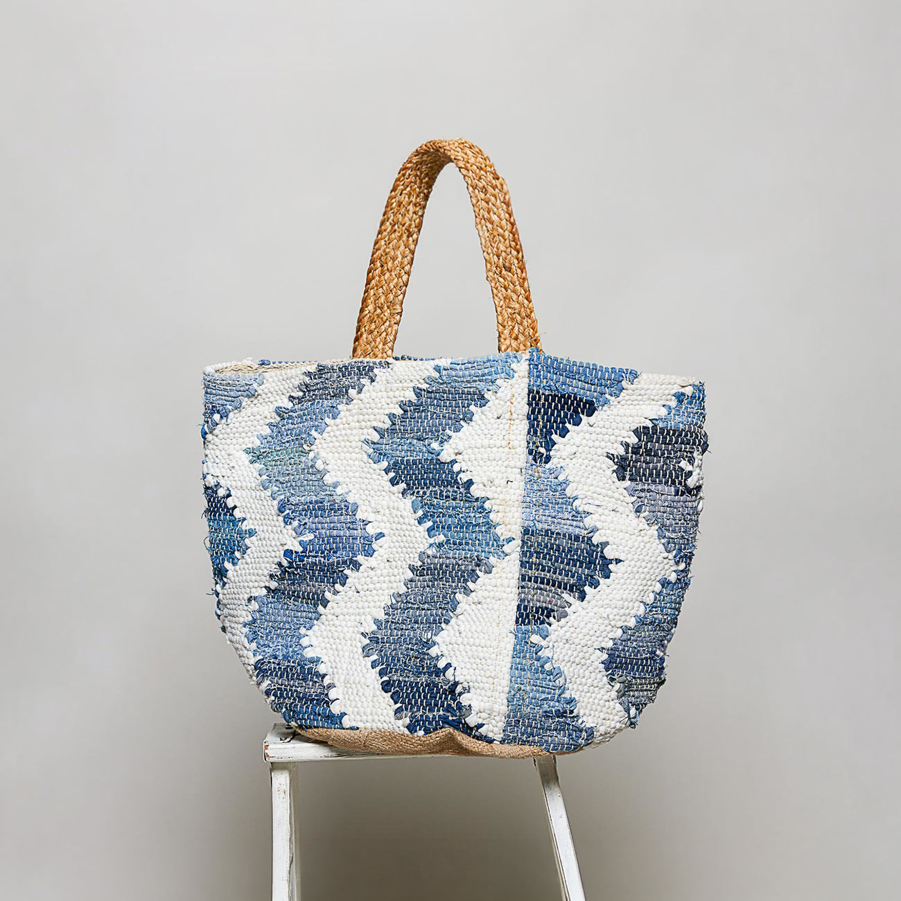POL Clothing Denim Multi handwoven tote bag, side view showing blue and white chevron woven texture and braided handles
