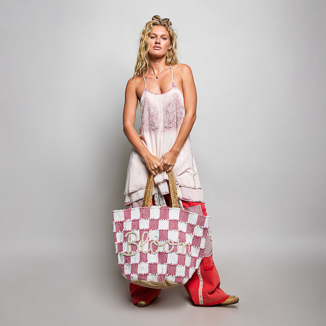 POL Clothing Pink BLOOM handwoven tote bag, close front view highlighting raised rope Bloom lettering and checker weave
