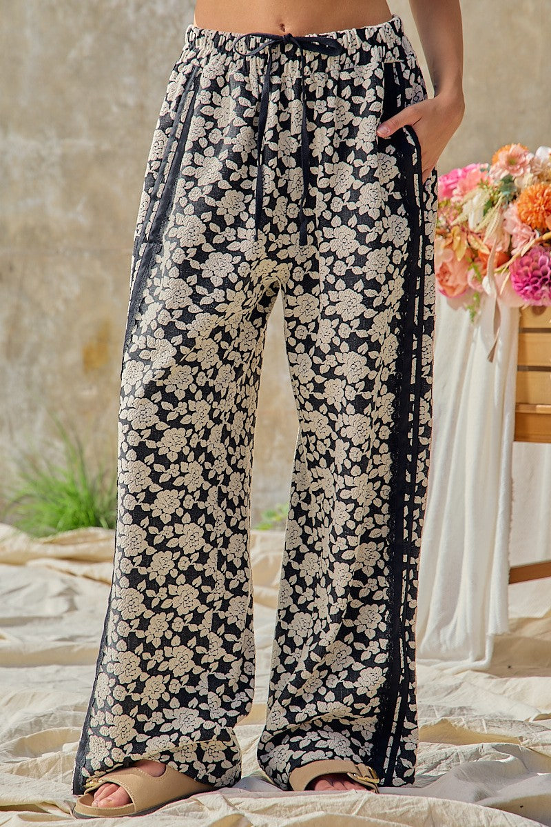 BiBi women's black floral jacquard wide leg pants with contrast side stripe, full-length front view on model - BellanBlue
