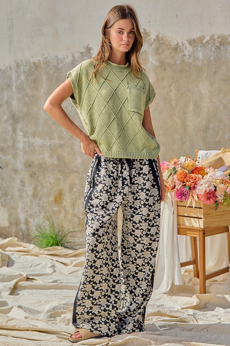 BiBi women's black floral wide leg pants with navy side stripe, three-quarter front view on model
