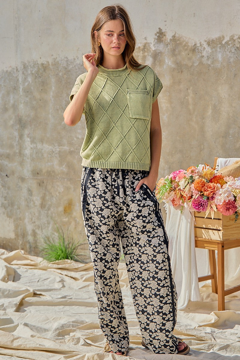 BiBi women's black floral wide leg pants with navy side stripe, three-quarter front view on model
