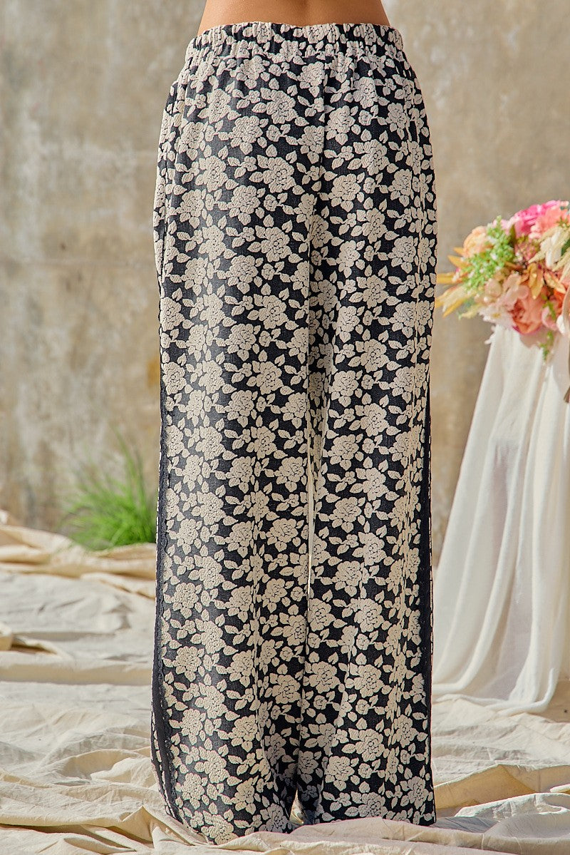 BiBi women's black cream floral jacquard wide leg pants, full-length back view on model
