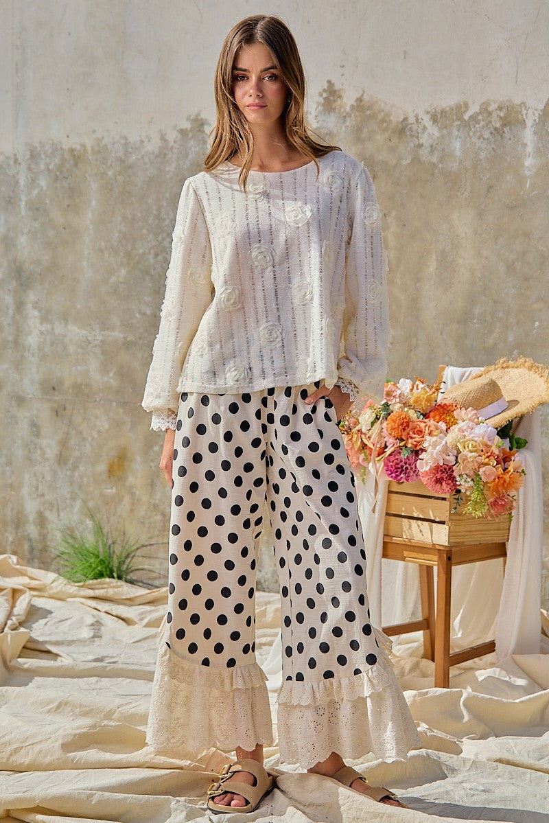 BiBi women's cream black polka dot wide leg pants, close-up eyelet lace ruffle hem detail
