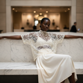 Women's cream mesh bow top, sheer lace fabric, high neck, draped silhouette, seated editorial - BellanBlue