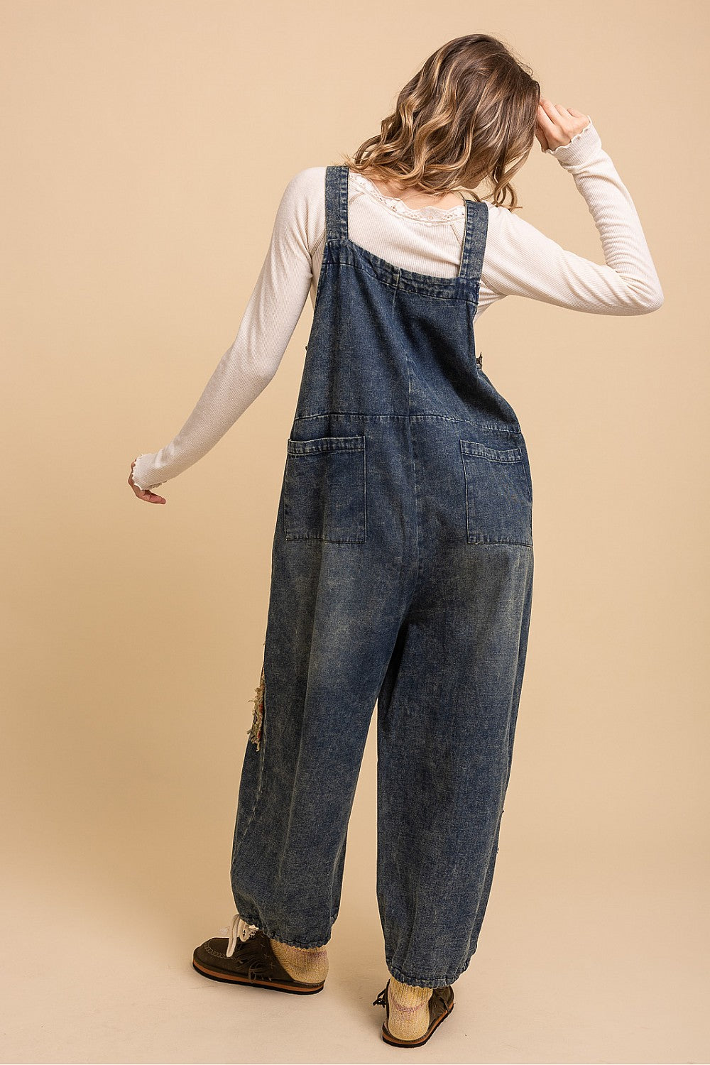 Bluevelvet denim patchwork overalls on model, side view showing pocket and tapestry patch detail on leg
