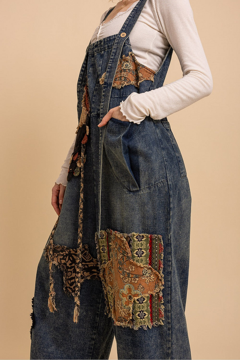 Bluevelvet denim patchwork overalls on model, close-up upper body showing adjustable strap button hardware
