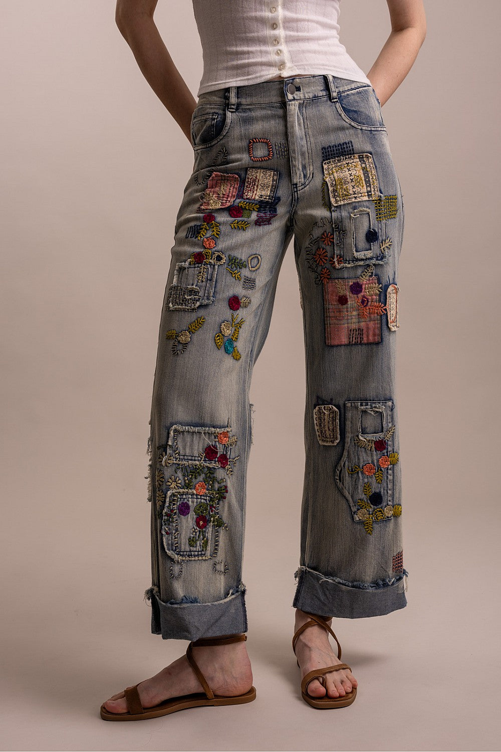 Blue Velvet women's denim wide-leg pants with colorful patchwork and floral embroidery, three-quarter front view on model - BellanBlue
