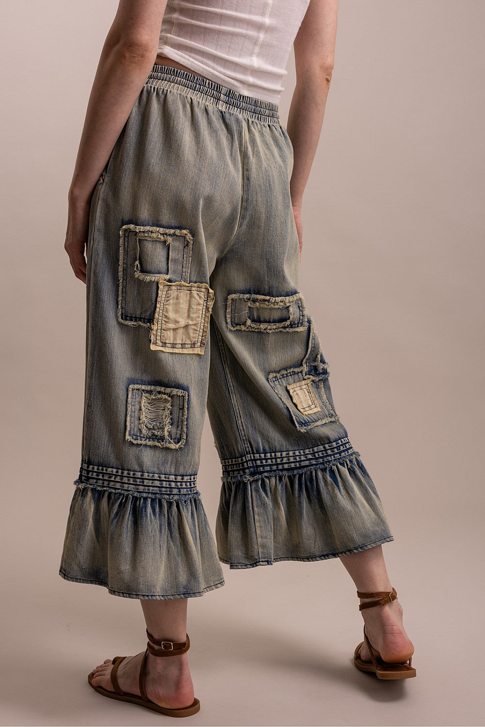 Blue Velvet women's denim patchwork ruffle-hem pants, rear three-quarter supplier view
