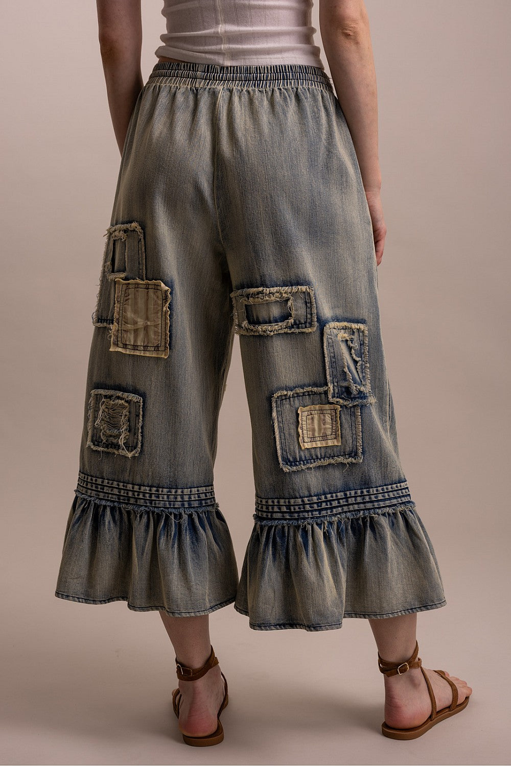 Blue Velvet women's denim pants, rear view of rectangular patches and cropped ruffle hems
