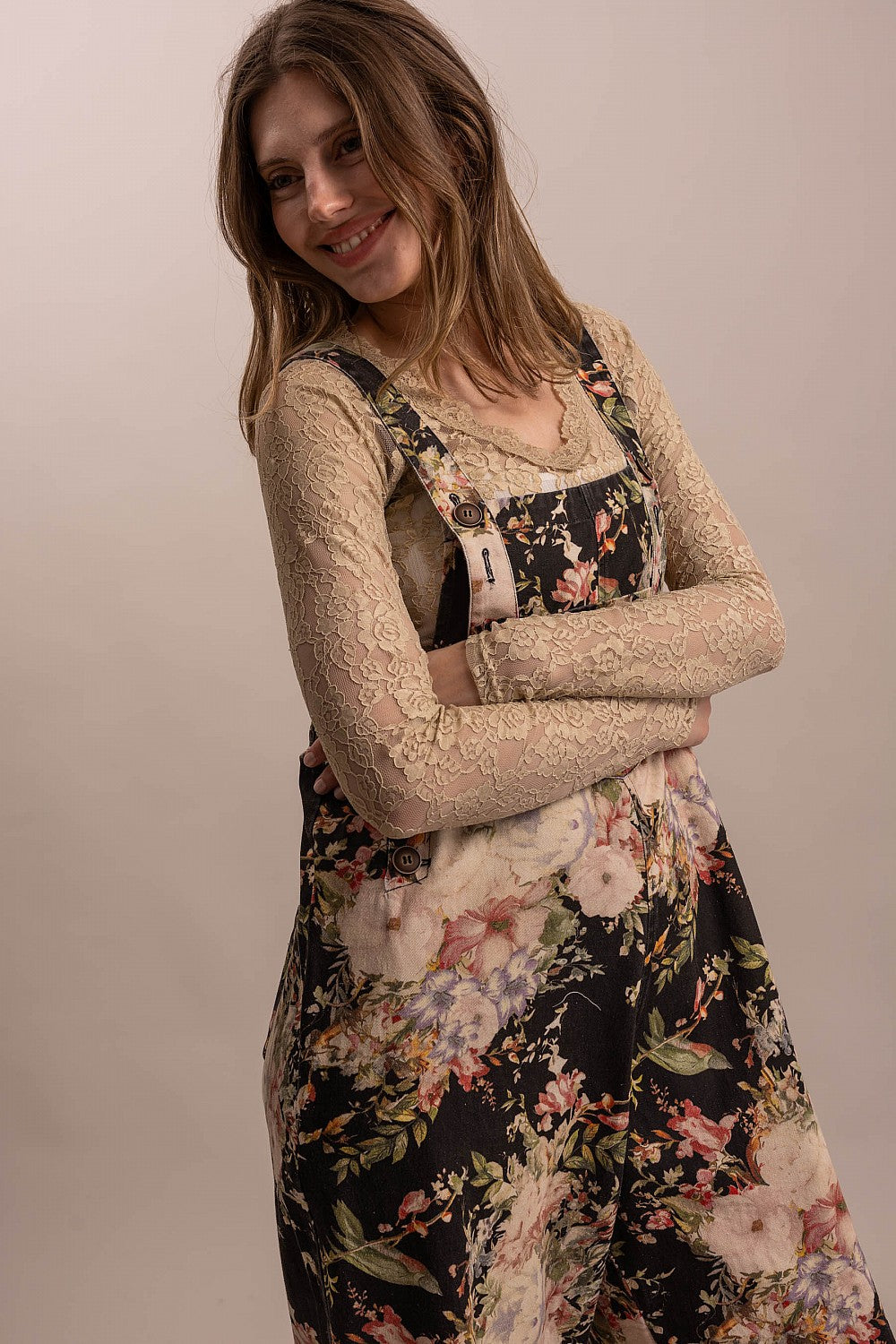 Bluevelvet black floral overalls three-quarter view showing bib buttons and floral print detail

