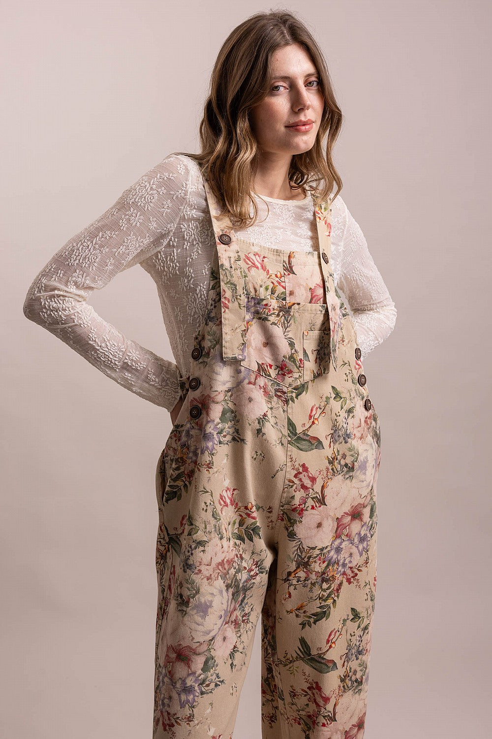 Bluevelvet taupe floral overalls three-quarter front view showing bib, buttons, and side pocket

