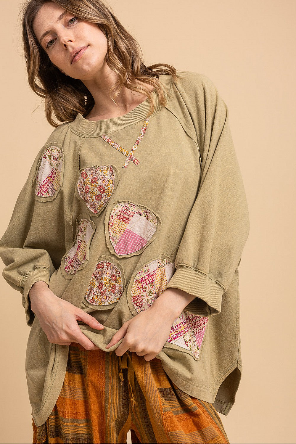 Blue Velvet sage heart patchwork sweatshirt, close front view showing floral heart appliques and raglan sleeves