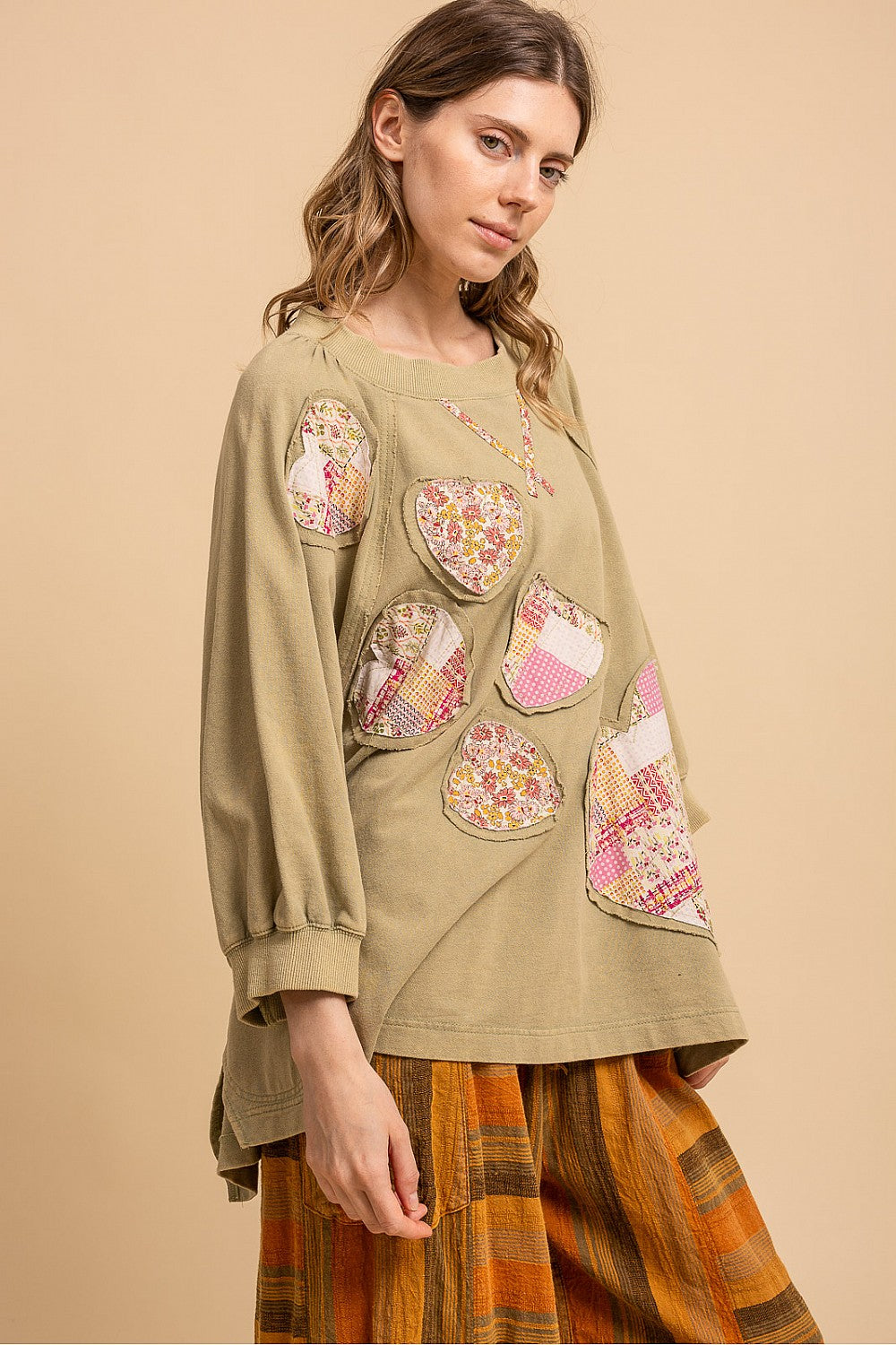 Blue Velvet sage heart patchwork sweatshirt, three-quarter side view showing heart appliques and tunic length
